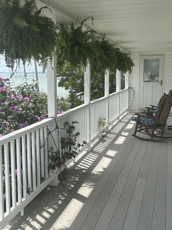 wooden deck featuring a water view