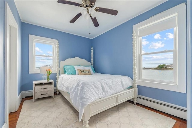 158 Cadish, Hull, MA 02045 - bedroom featuring a baseboard heating unit, wood finished floors, and baseboards