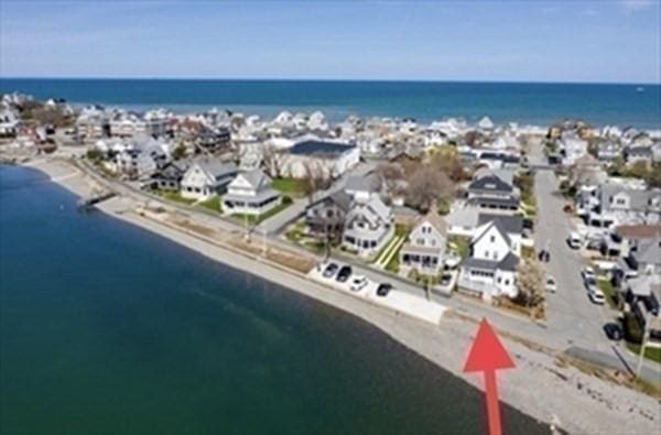 aerial view of residential area with a nearby body of water