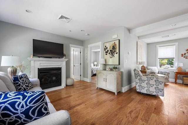 599 Washington St Unit 1, Pembroke, MA 02359 - living area featuring light wood-style flooring, a glass covered fireplace, and recessed lighting