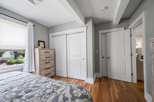 599 Washington St Unit 1, Pembroke, MA 02359 - bedroom featuring light wood-style floors, a closet, and beam ceiling