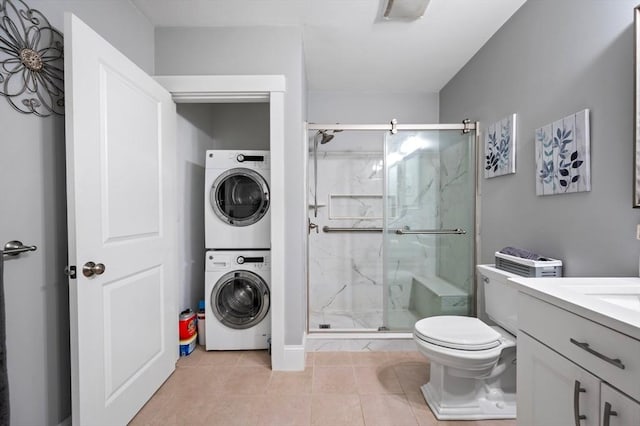 599 Washington St Unit 1, Pembroke, MA 02359 - bathroom with stacked washer and clothes dryer, a marble finish shower, tile patterned floors, and vanity