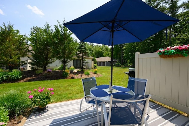 599 Washington St Unit 1, Pembroke, MA 02359 - wooden terrace with outdoor dining space, a yard, and a patio