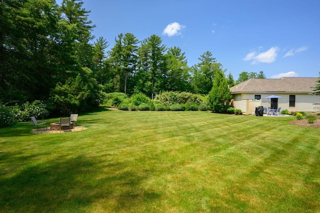 599 Washington St Unit 1, Pembroke, MA 02359 - view of grassy yard featuring an outdoor fire pit