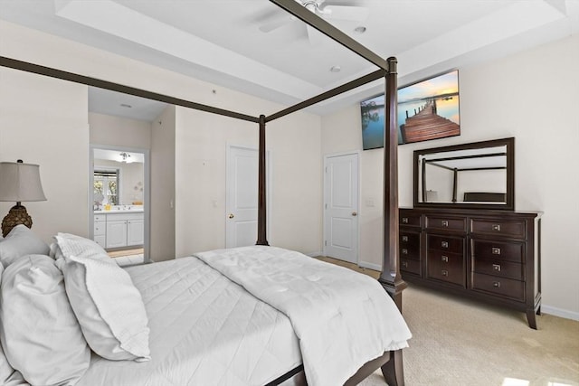 bedroom with light colored carpet, connected bathroom, and baseboards