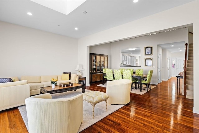living room featuring stairway, baseboards, recessed lighting, and wood finished floors