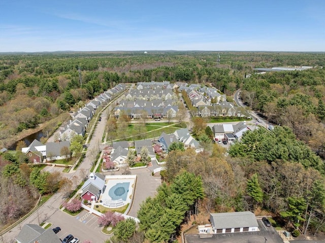 drone / aerial view with a residential view and a wooded view