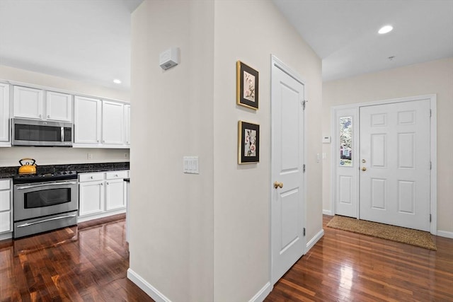 hallway with baseboards, recessed lighting, and dark wood-style floors