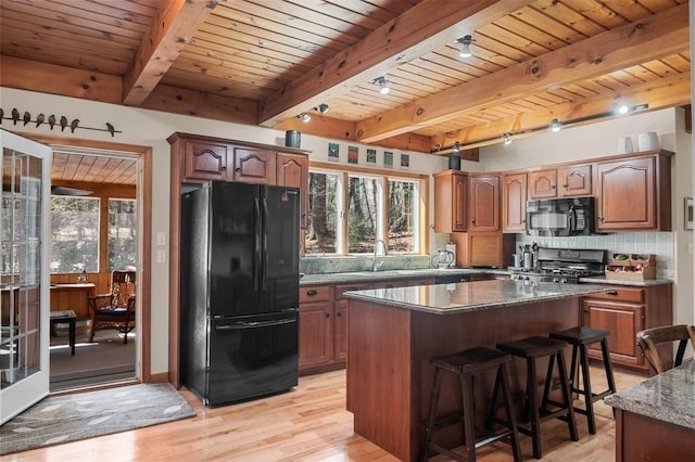 kitchen featuring a healthy amount of sunlight, wooden ceiling, black appliances, and light wood finished floors