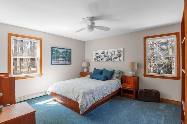 bedroom with carpet floors, a baseboard radiator, and multiple windows