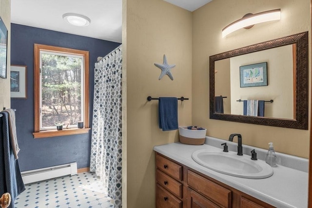 full bathroom with vanity, a shower with shower curtain, and baseboard heating