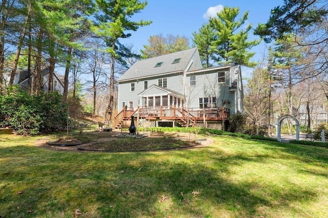 back of house with a sunroom, stairway, a lawn, and a deck
