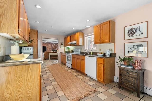 kitchen with a baseboard heating unit, sink, and white appliances