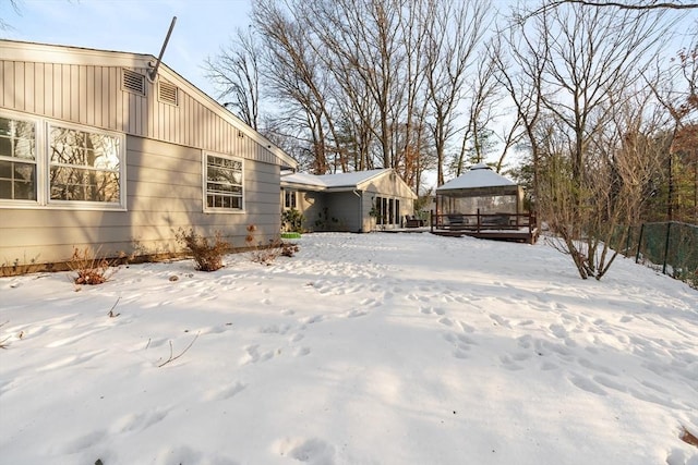 yard covered in snow with a gazebo