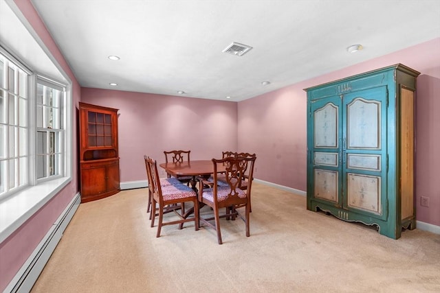 carpeted dining room featuring a baseboard radiator