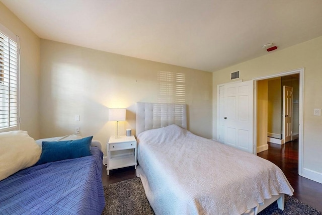 bedroom featuring dark wood-type flooring