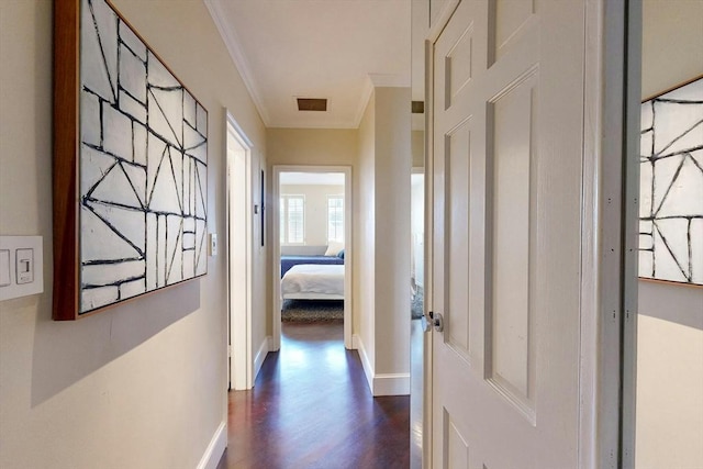 hallway featuring ornamental molding and dark hardwood / wood-style floors