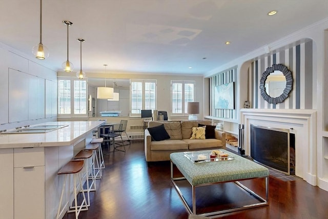 living room with crown molding, dark wood-type flooring, and a healthy amount of sunlight