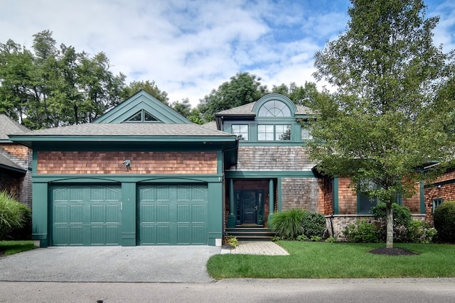 view of front of house featuring a front yard and a garage