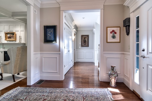 entryway featuring dark hardwood / wood-style flooring and crown molding