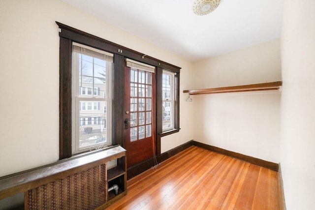 doorway to outside with wood-type flooring