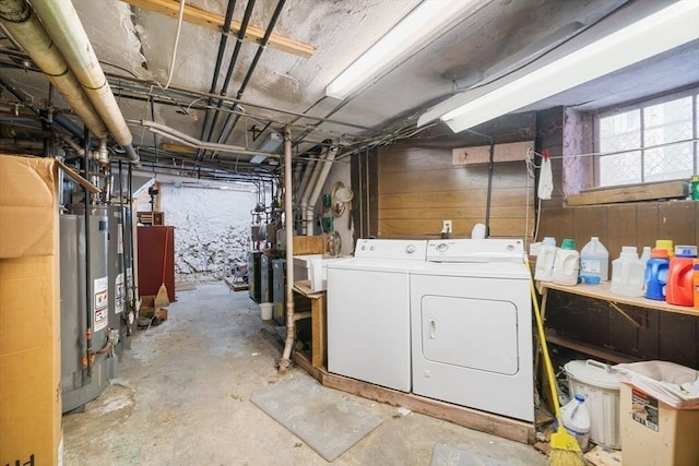 basement featuring water heater and washer and dryer