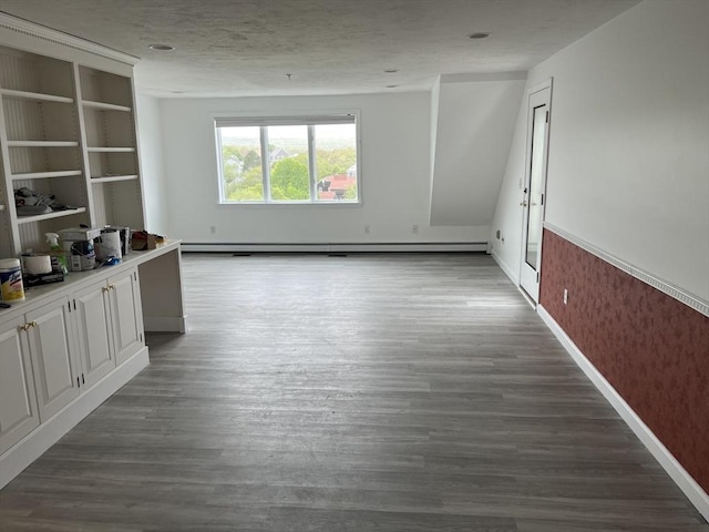 24 Highland Ter Unit 2415, Plymouth, MA 02360 - unfurnished living room featuring wood finished floors, a baseboard heating unit, and baseboards