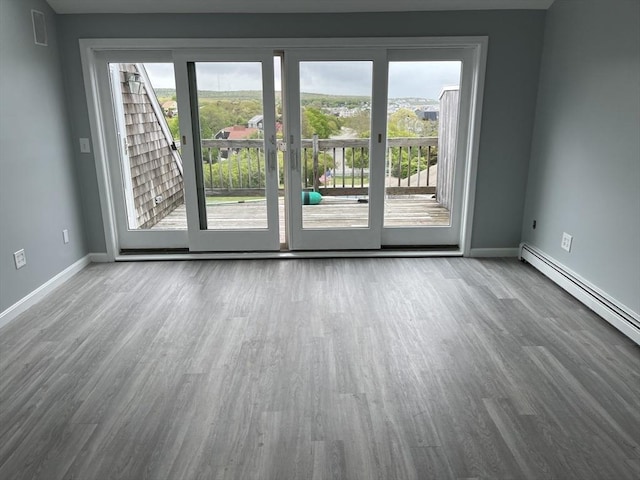 24 Highland Ter Unit 2415, Plymouth, MA 02360 - spare room with wood finished floors, baseboards, and a baseboard radiator