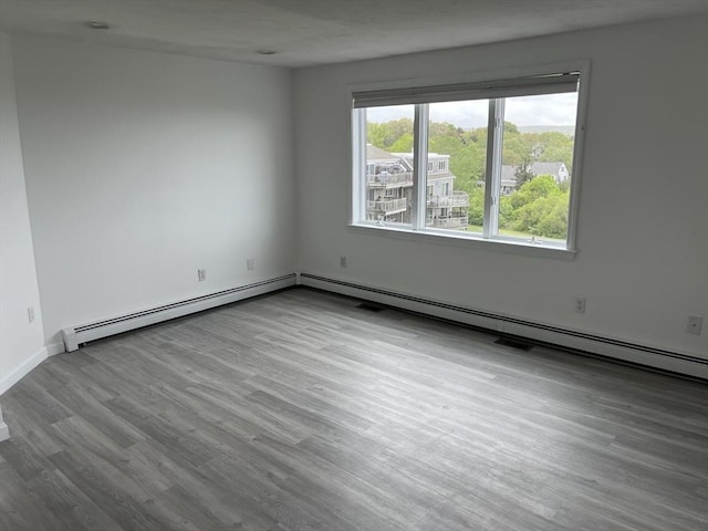 24 Highland Ter Unit 2415, Plymouth, MA 02360 - empty room with wood finished floors, baseboard heating, and baseboards