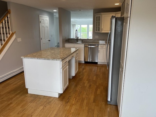 24 Highland Ter Unit 2415, Plymouth, MA 02360 - kitchen featuring appliances with stainless steel finishes, dark wood finished floors, recessed lighting, a kitchen island, and a sink