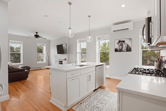 kitchen with stainless steel appliances, a baseboard radiator, light countertops, a sink, and a wall mounted air conditioner