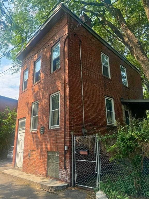 10 Eldridge Pl, Chelsea, MA 02150 - view of side of property with brick siding and a gate