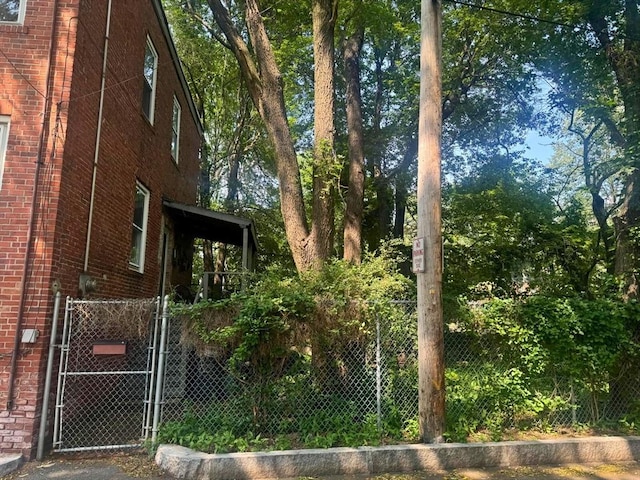 10 Eldridge Pl, Chelsea, MA 02150 - view of home's exterior featuring brick siding and a gate