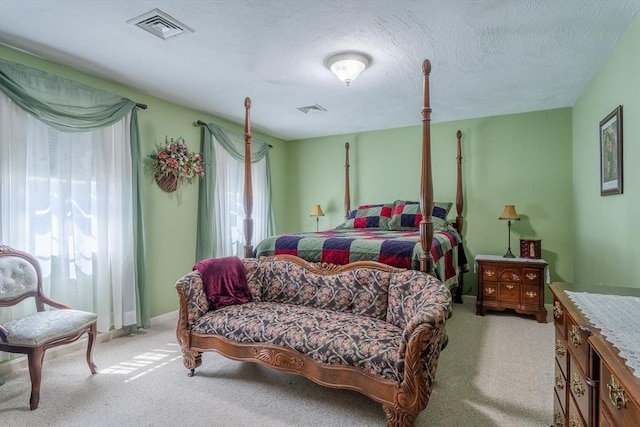 bedroom with visible vents and light colored carpet