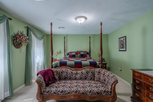 carpeted bedroom with baseboards and visible vents