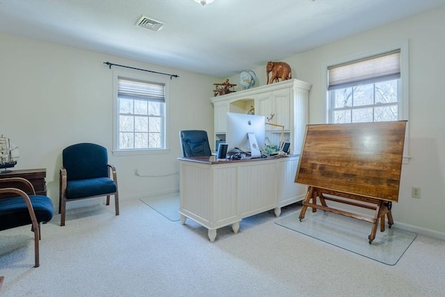 home office featuring a wealth of natural light, baseboards, and visible vents