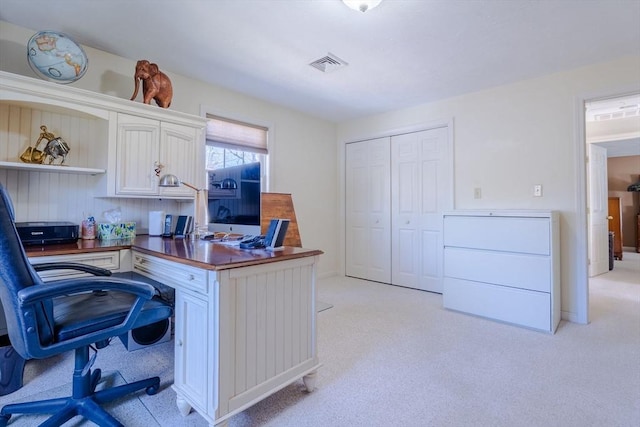 office area with visible vents and light colored carpet
