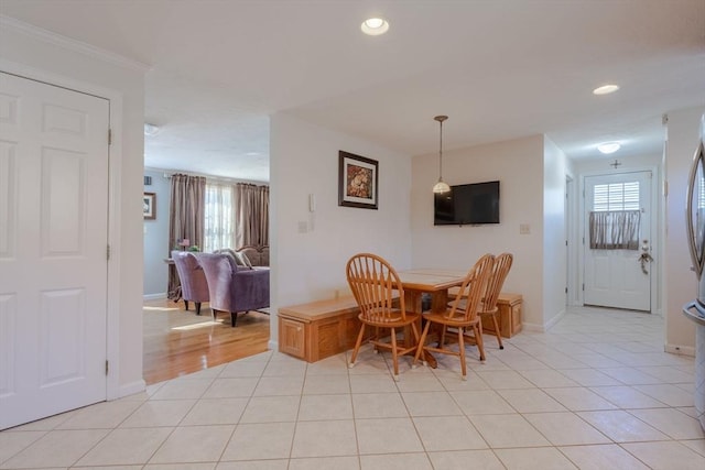 dining area with light tile patterned flooring, a healthy amount of sunlight, and recessed lighting