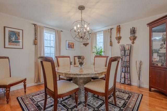 dining room with a wealth of natural light, light wood finished floors, and an inviting chandelier