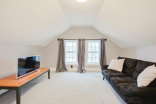 carpeted living room with lofted ceiling