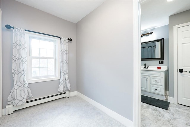 interior space with a baseboard radiator and vanity