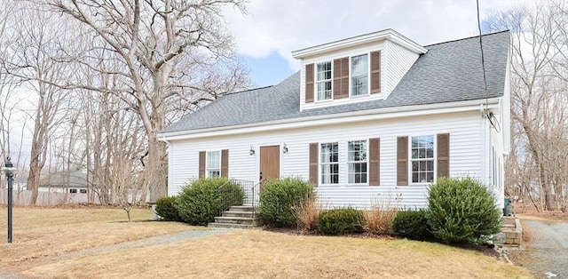 cape cod-style house with a front yard