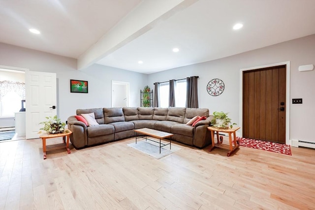 living room with beamed ceiling, a baseboard radiator, and light hardwood / wood-style flooring