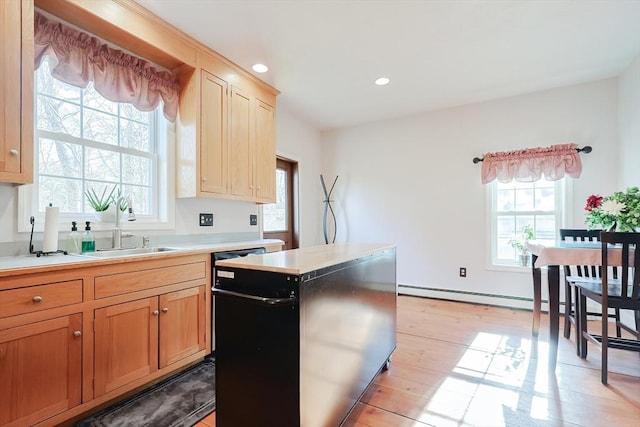 kitchen with a baseboard radiator, sink, and light wood-type flooring