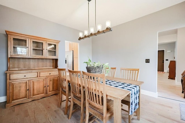 dining room featuring a chandelier and light hardwood / wood-style flooring