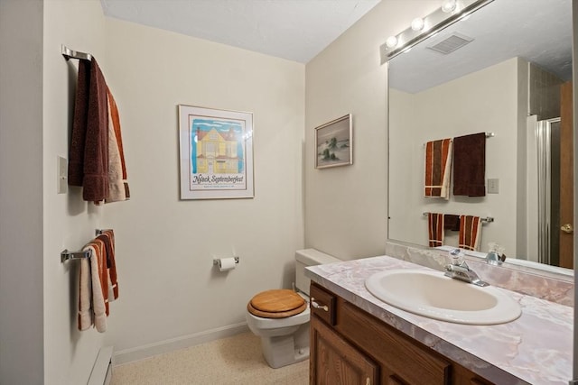 bathroom with toilet, vanity, and baseboards