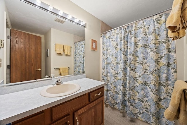 full bath with vanity and curtained shower