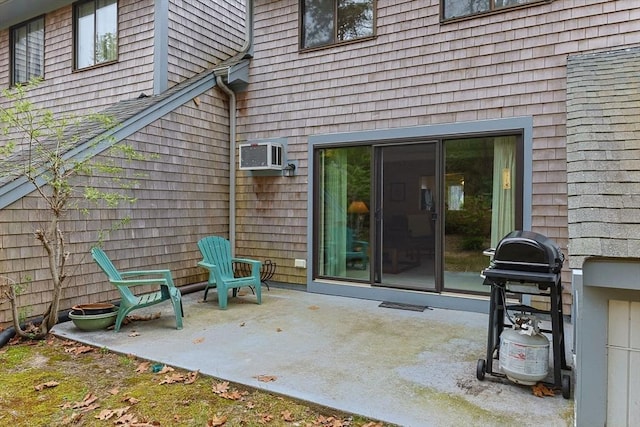 property entrance with a patio and a wall mounted AC