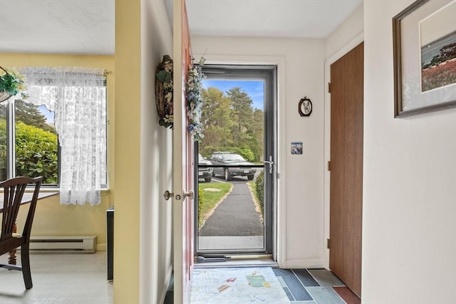 doorway to outside featuring baseboard heating and baseboards