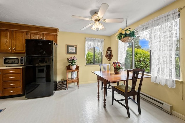 dining area featuring baseboard heating, baseboards, and ceiling fan